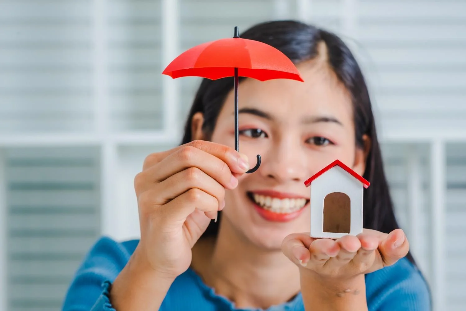 Homeowner reviewing home insurance documents at a kitchen table
